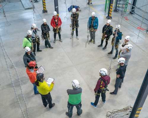 Group of construction workers gathered in a circle.